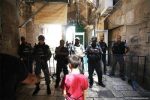 A Palestinian boy stands in front of Israeli soldiers who have blocked the entrance to Al-Mosque on 18 July 2017 Mostafa AlkharoufAnadolu Agency