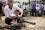 israeli-man-shown-his-son-how-use-use-a-machine-gun-israeli-children-gun-at-west-bank-settlement-efrat