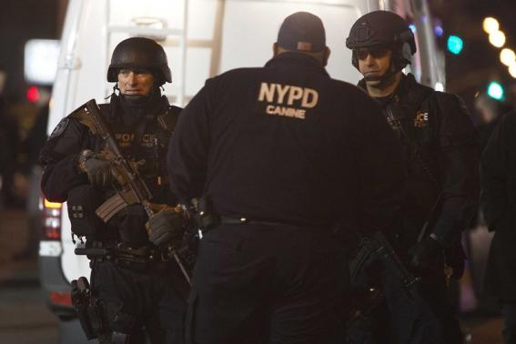Policemen are pictured at the scene of a shooting where two New York Police officers were shot dead in the Brooklyn borough of New York