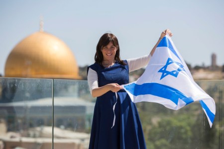 Portrait of Likud parliament member Tzipi Hotovely, holds the Israeli flag with the Dome of the Rock behind her on May 1, 2014. Photo by Yonatan Sindel/Flash90 *** Local Caption *** ????? ??? ????? ?????? ???? ???????