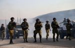 Israeli-soliders-gather-and-aim-tear-gas-at-palestinian-protestors-in-west-bank-nablus