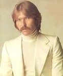 a-person-with-a-mustache-and-a-white-turtleneck-d